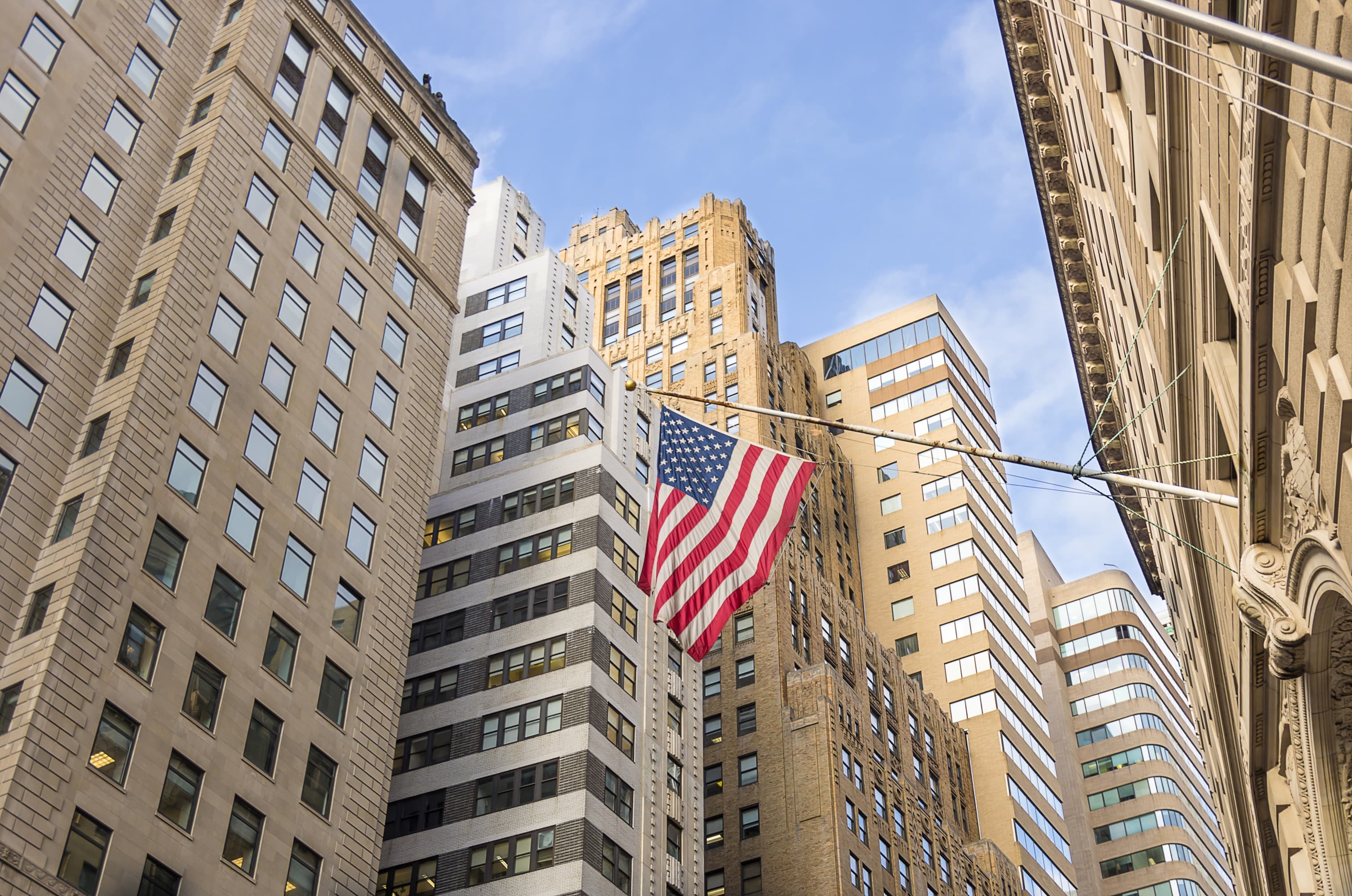 American Flag flying over Wall Street in New York City, New York, USA